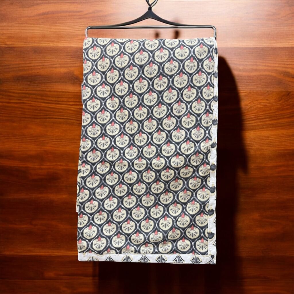 Art Deco reversible cotton dohar in black, cream and gold hanging against dark wood